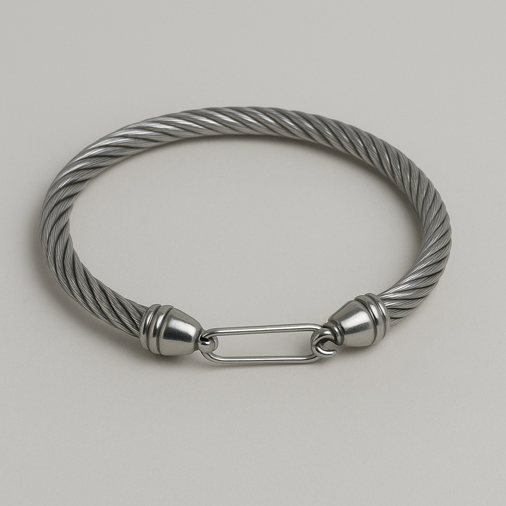 Stylish metallic bracelet with twisted design and secure clasp on a neutral background.